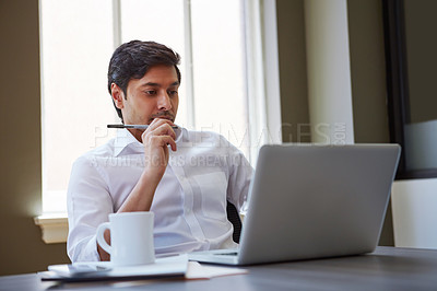 Buy stock photo Cropped shot of a businessman working at his desk