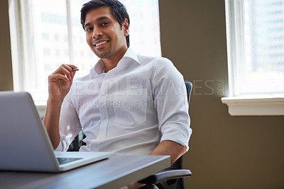 Buy stock photo Cropped shot of a businessman working at his desk