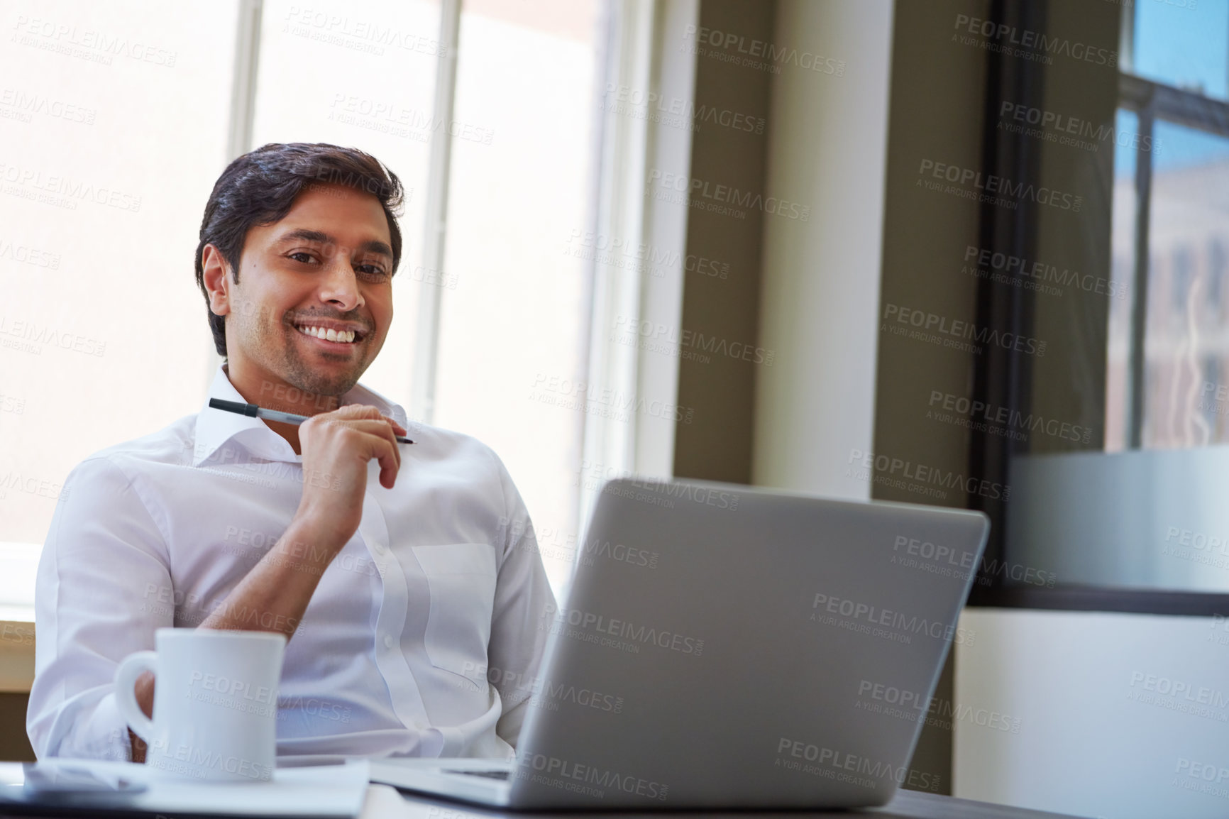 Buy stock photo Cropped shot of a businessman working at his desk