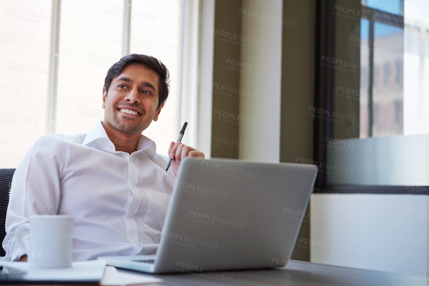 Buy stock photo Cropped shot of a businessman working at his desk