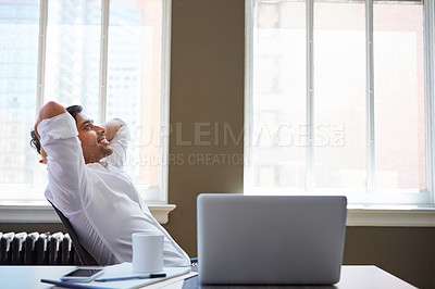 Buy stock photo Shot of a happy businessman leaning back in his chair