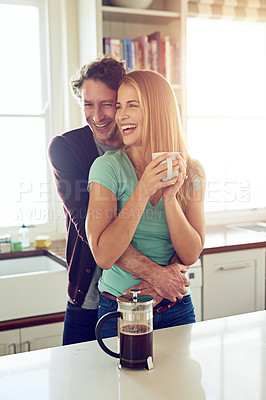 Buy stock photo Shot of an affectionate couple in the kitchen