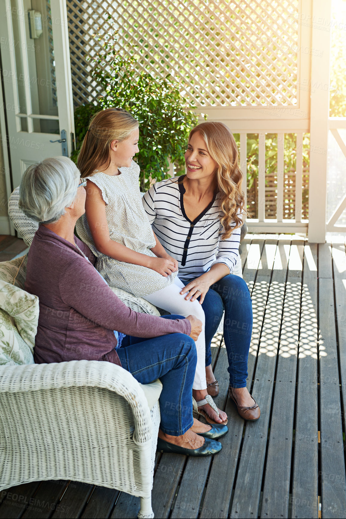 Buy stock photo Full length shot of a young girl sitting outside with her mother and grandmother