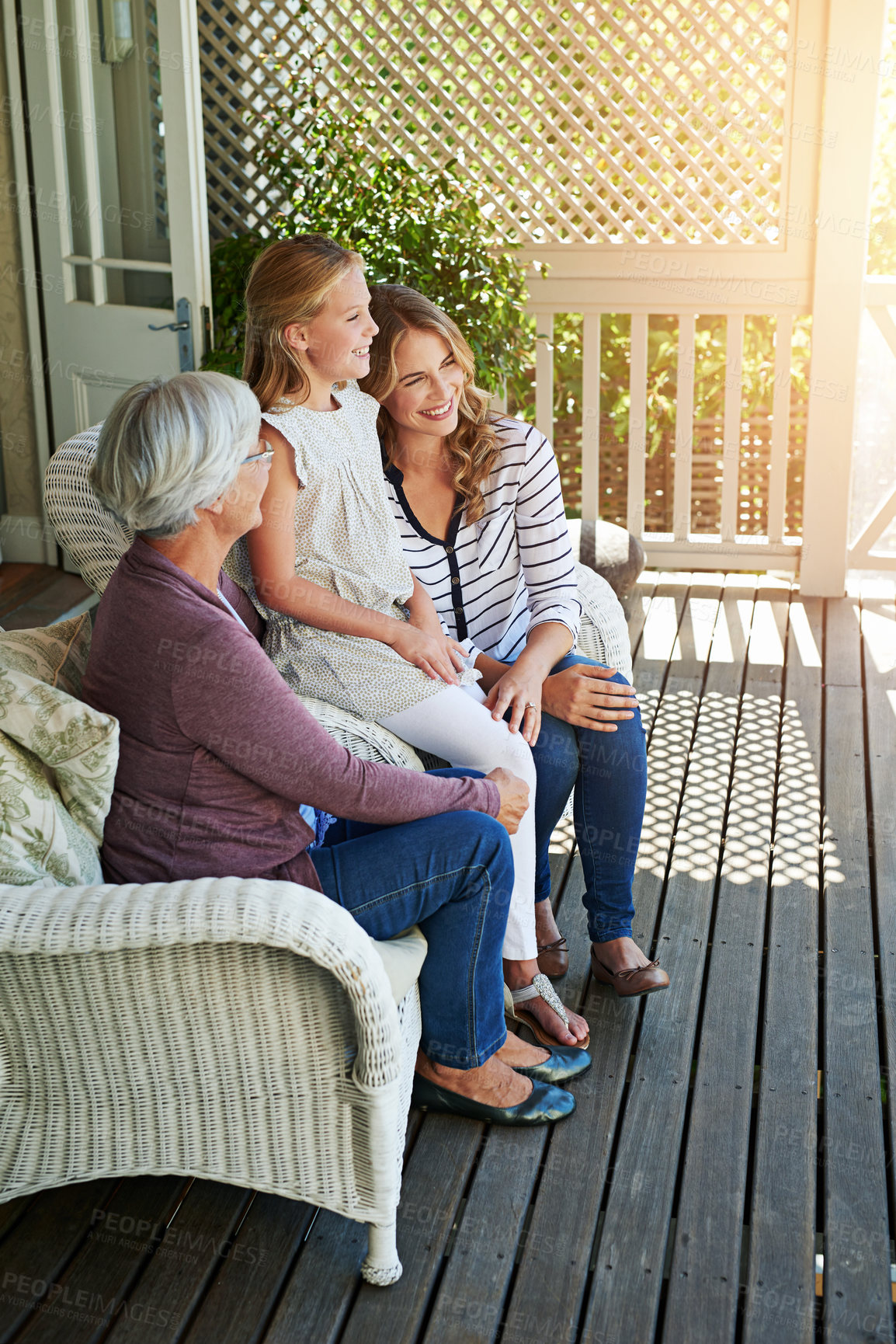 Buy stock photo Full length shot of a young girl sitting outside with her mother and grandmother