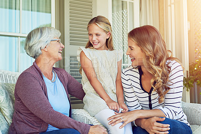 Buy stock photo Cropped shot of a young girl sitting outside with her mother and grandmother