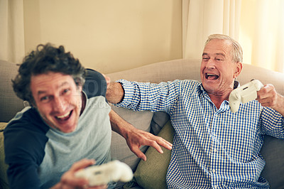 Buy stock photo Cropped shot of a man and his elderly father playing video games at home