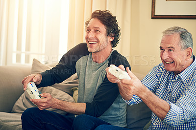 Buy stock photo Cropped shot of a man and his elderly father playing video games at home