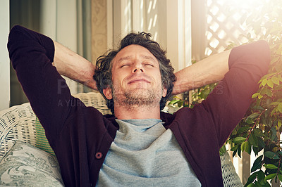 Buy stock photo Cropped shot of a man relaxing outside his home