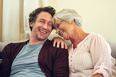 Buy stock photo Cropped shot of a man and his elderly mother relaxing at home