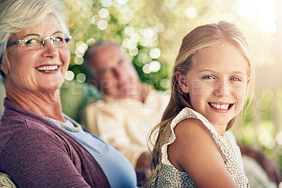 Buy stock photo Cropped portrait of a young girl sitting outside with her grandparents