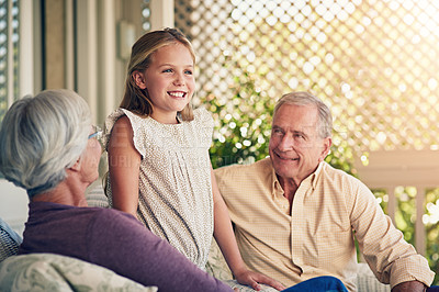 Buy stock photo Cropped shot of a young girl standing outside with her grandparents