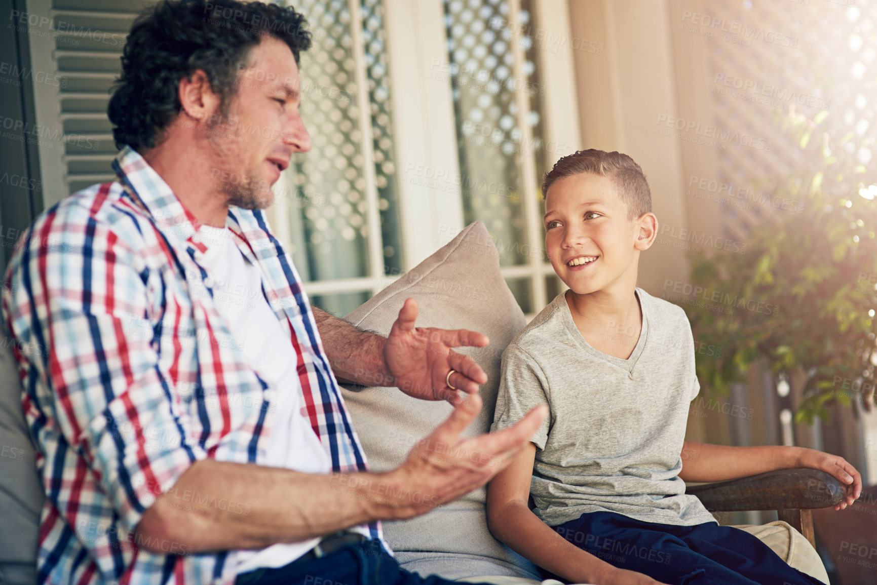 Buy stock photo Cropped shot of a father talking to his young son outside