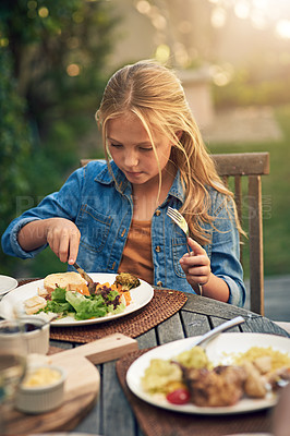 Buy stock photo Shot of a little girl having lunch outdoors