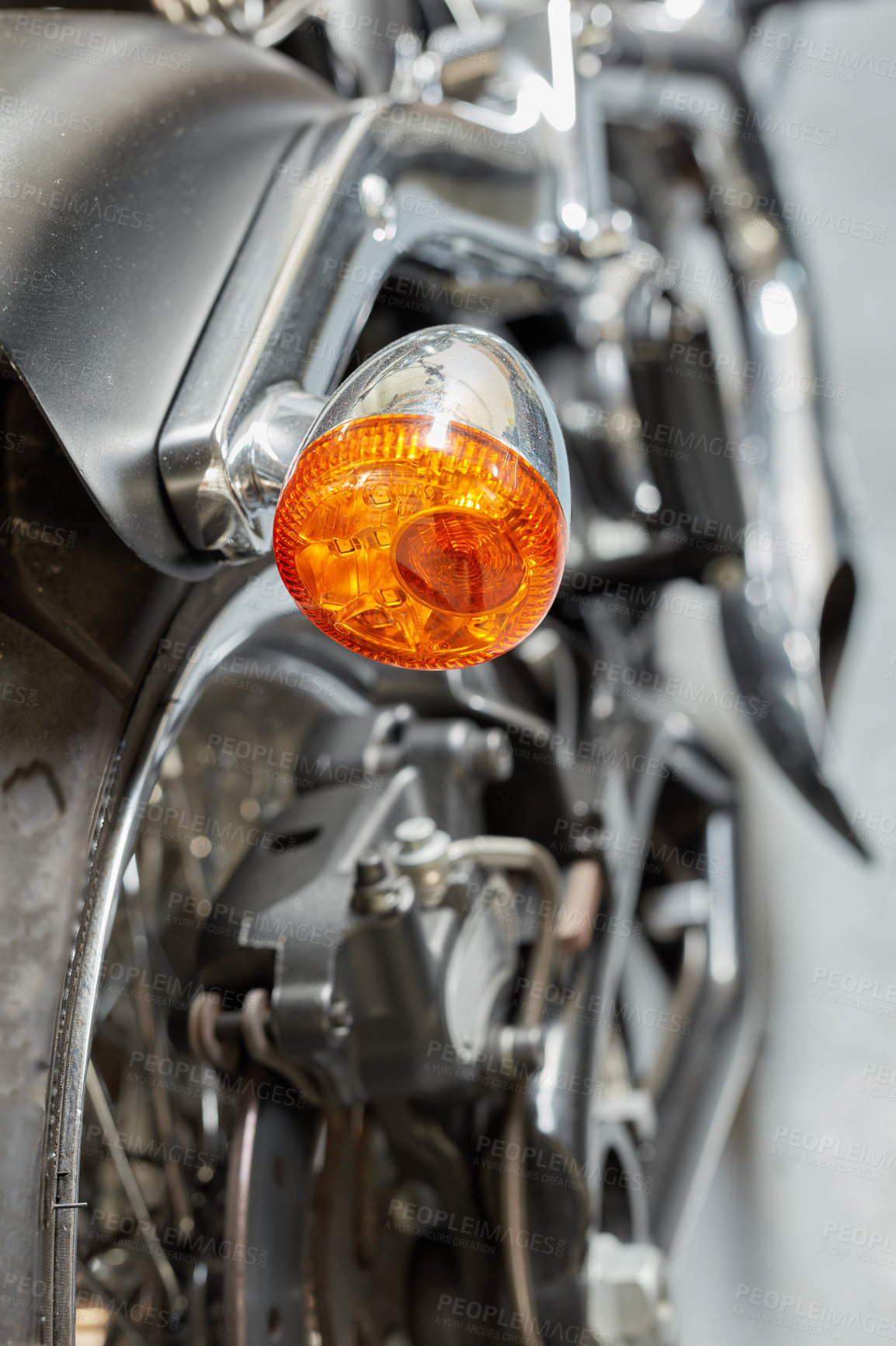Buy stock photo An orange turning light, signal and indicator on a shiny black motorbike. Closeup detailed texture of warning bulb used for road safety, precaution when riding on a highway or street. Safe motorists