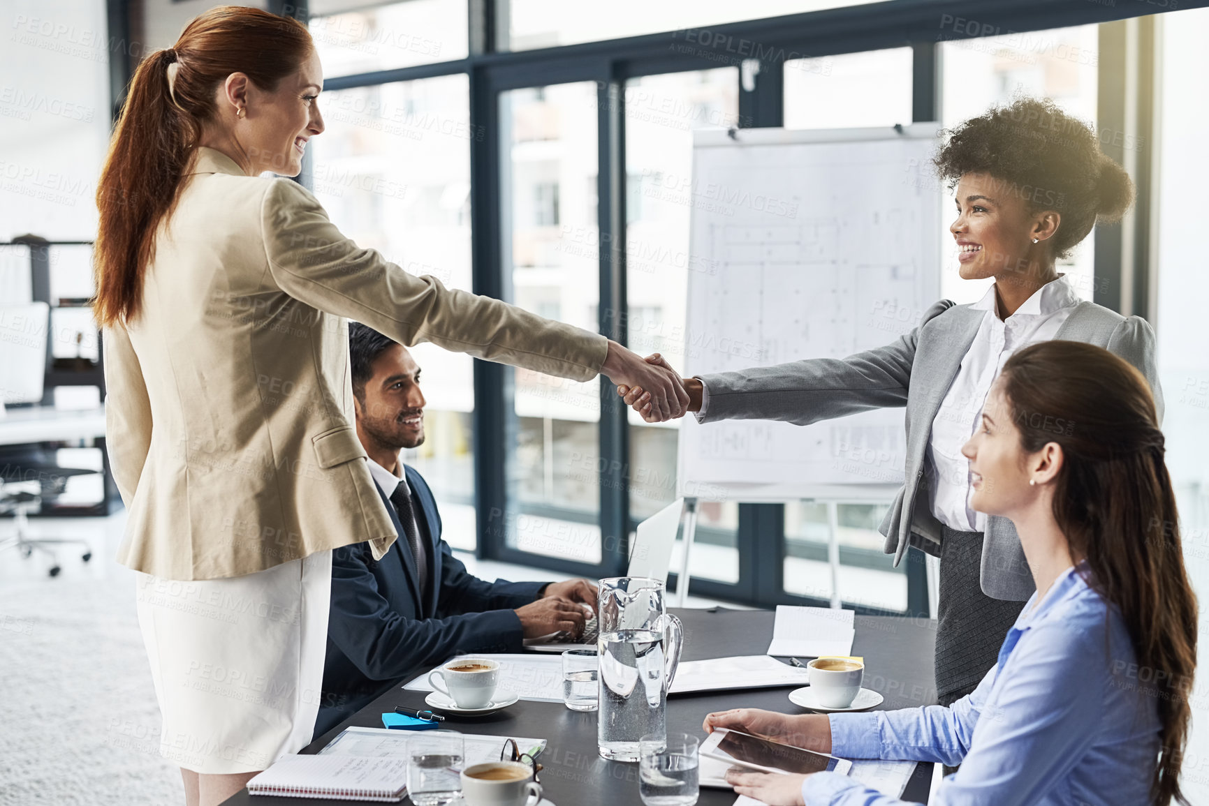 Buy stock photo Shot of businesspeople shaking hands during a meeting