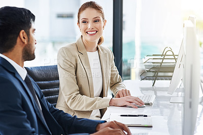 Buy stock photo Shot of two businesspeople using desktop computers