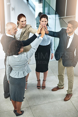 Buy stock photo Shot of a group of businesspeople giving a high-five