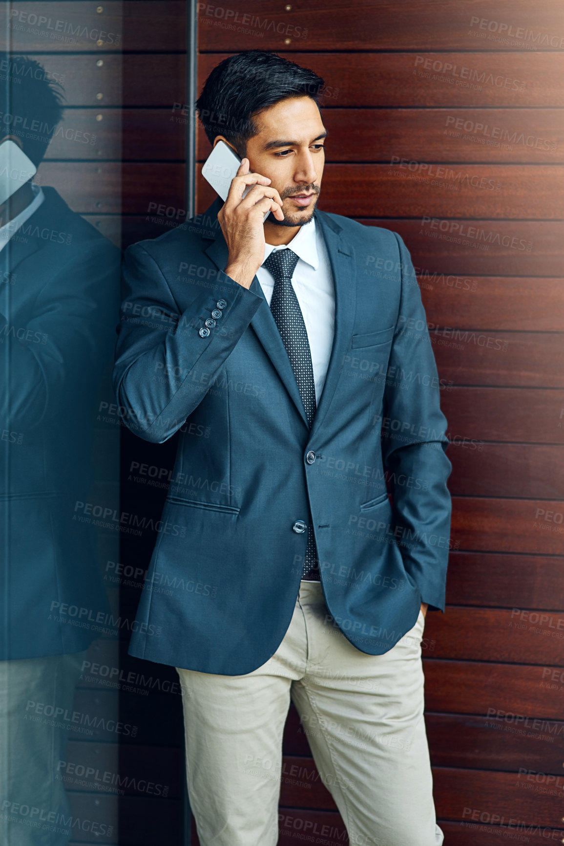 Buy stock photo Shot of a businessman taking a call outside the office