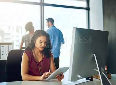 Buy stock photo Cropped shot of a young businesswoman working on a digital tablet in a modern office