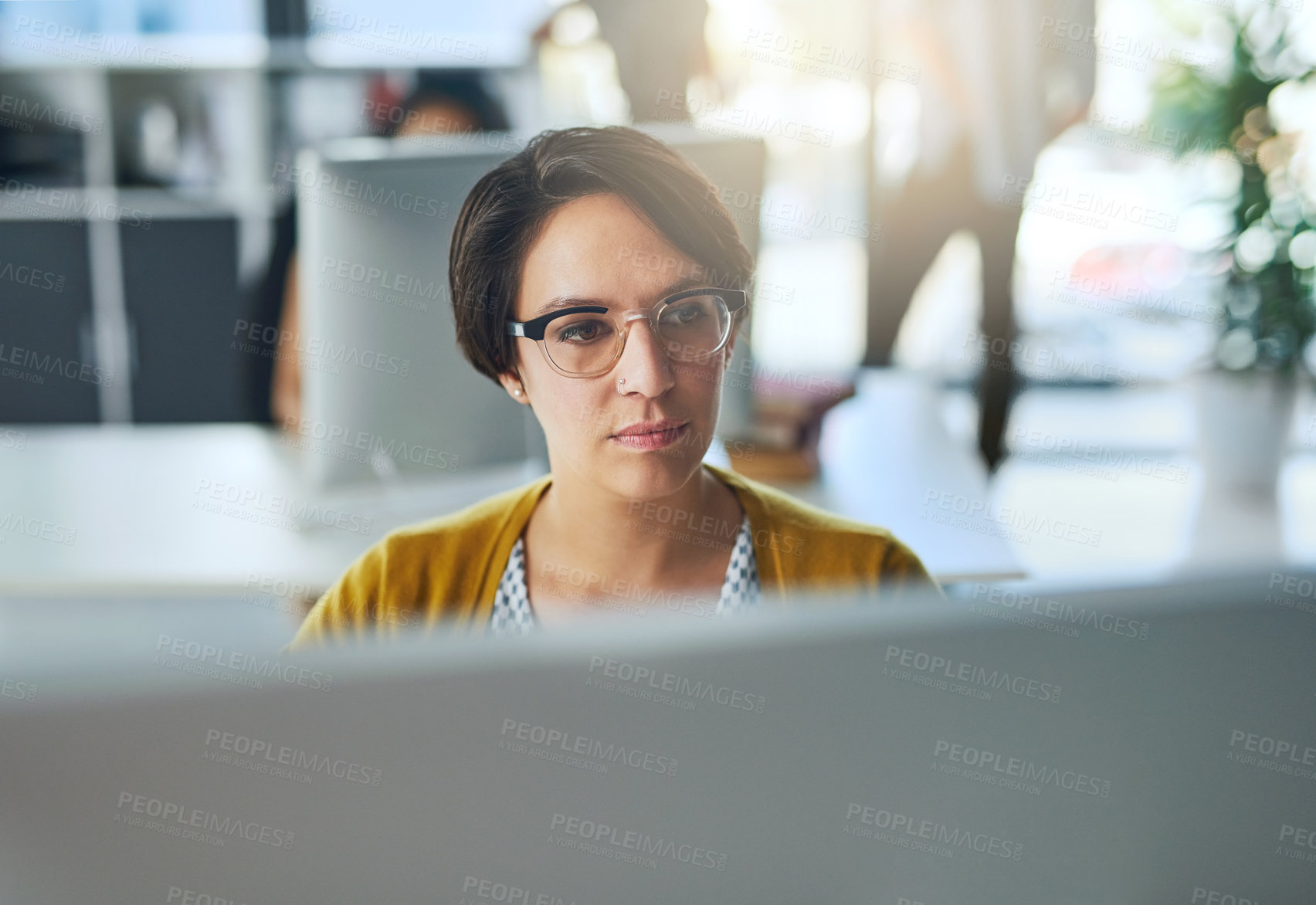 Buy stock photo Cropped shot of a young businesswoman working in a modern office