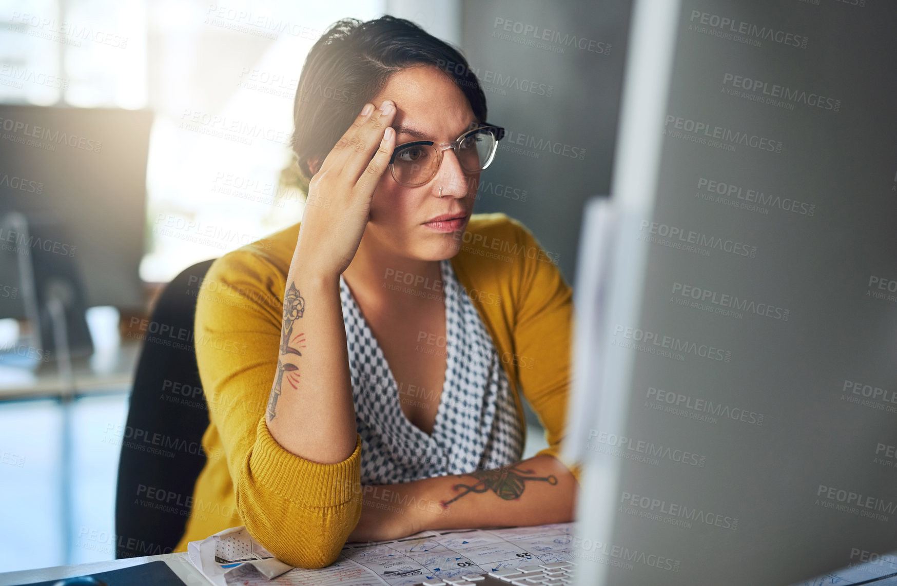 Buy stock photo Cropped shot of a young businesswoman looking stressed out at her desk
