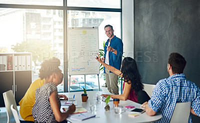 Buy stock photo Cropped shot of a businessman giving a presentation to his colleagues in a modern office