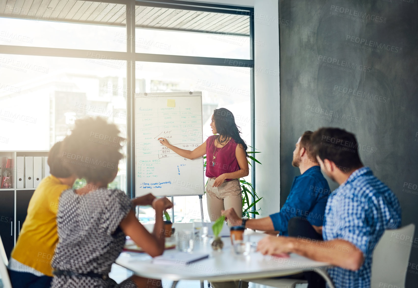 Buy stock photo Cropped shot of a businesswoman giving a presentation to her colleagues in a modern office