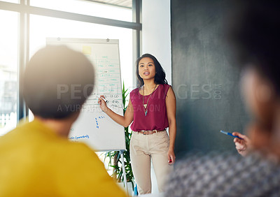 Buy stock photo Cropped shot of a businesswoman giving a presentation to her colleagues in a modern office