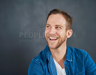Buy stock photo Cropped shot of a young businessman sitting against a grey background