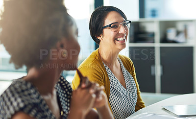 Buy stock photo Cropped shot of businesswomen having an office meeting together