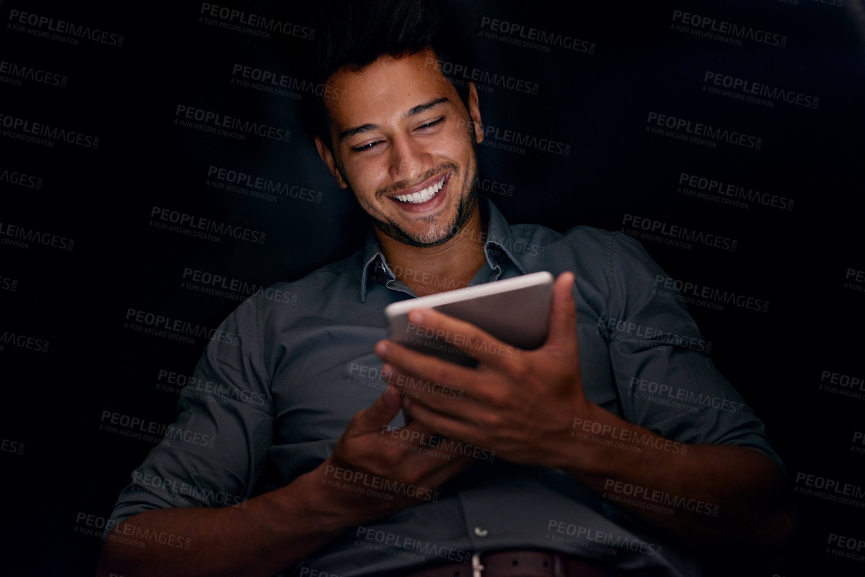 Buy stock photo Cropped shot of a young businessman working late on a digital tablet