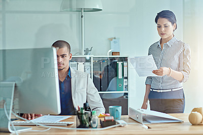 Buy stock photo Cropped shot of two businesspeople working in an office