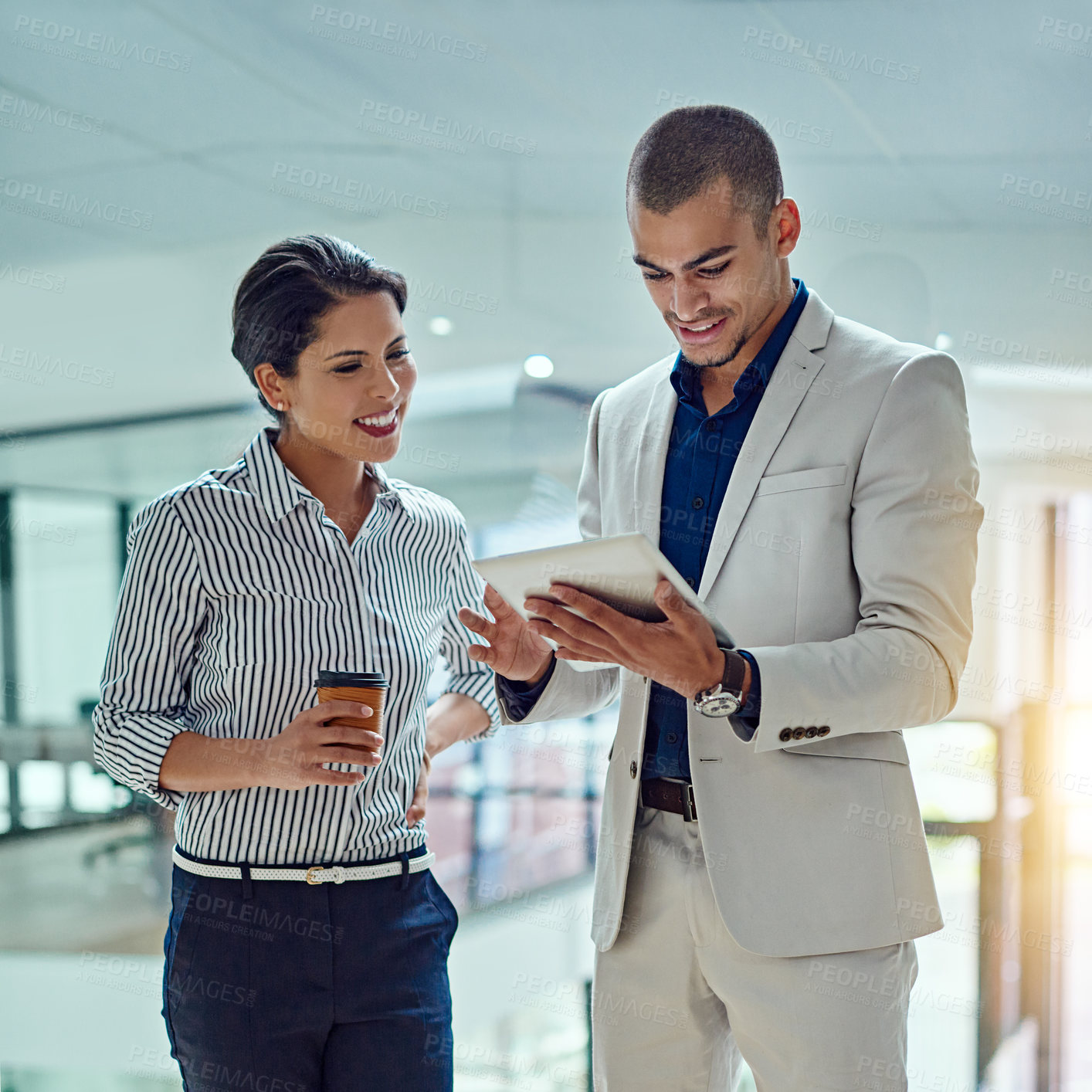 Buy stock photo Cropped shot of two businesspeople working together on a digital tablet in an office