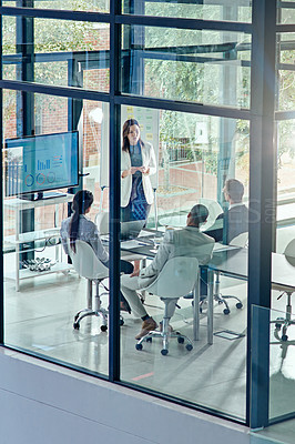 Buy stock photo Cropped shot of a businesswoman delivering a presentation in the boardroom