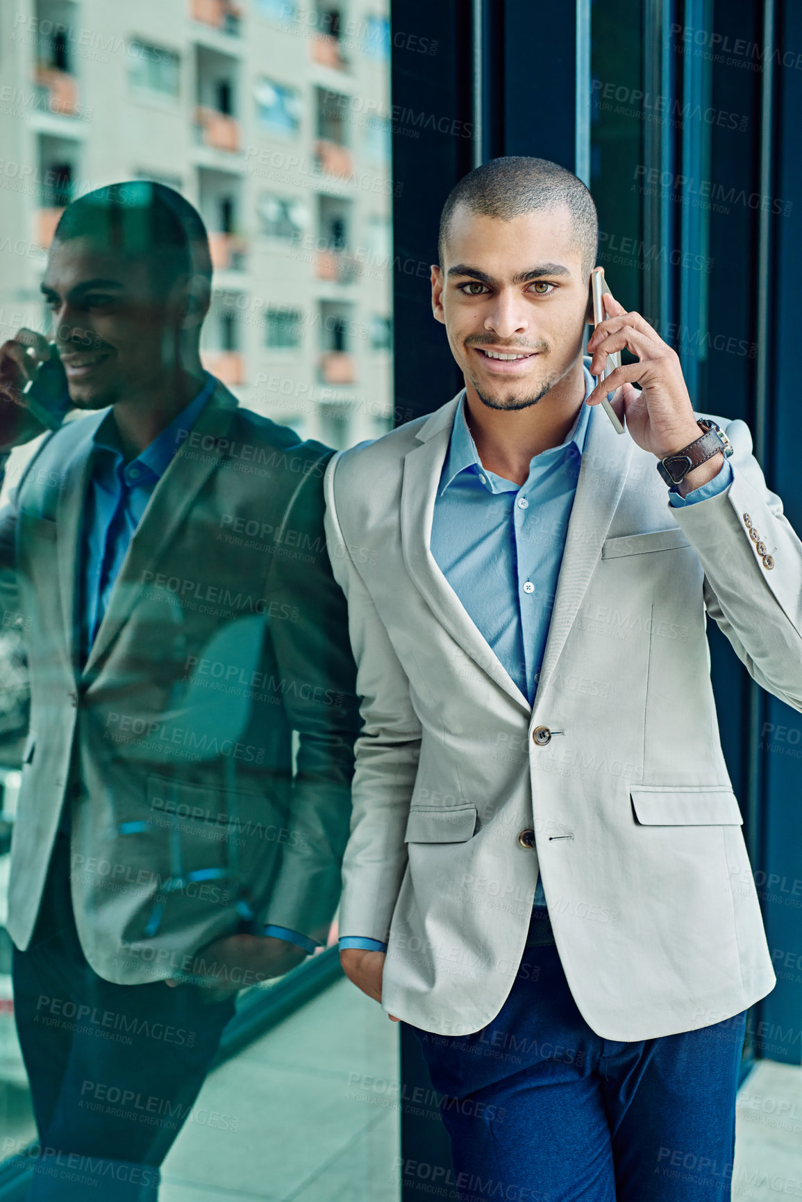 Buy stock photo Portrait of a young businessman using his phone at work
