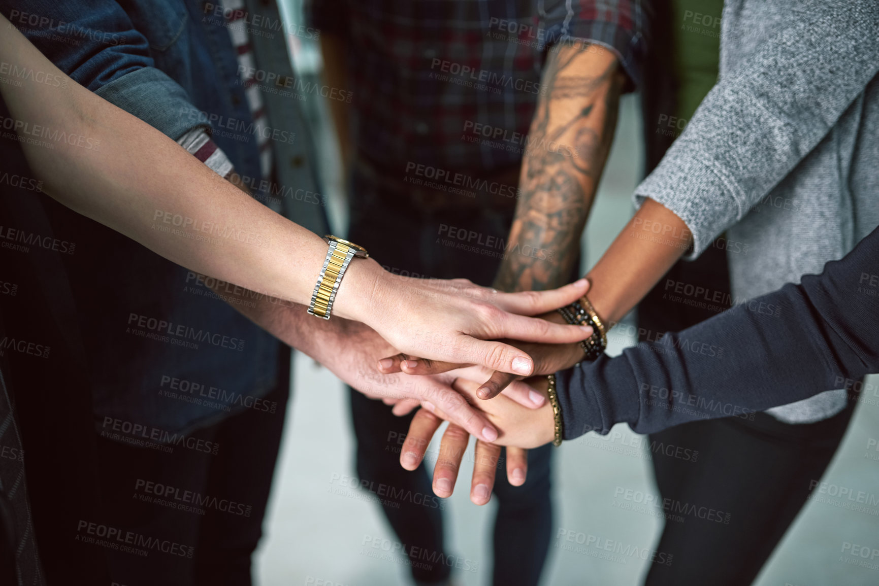 Buy stock photo Cropped shot of a group of people stacking their hands on top of each other