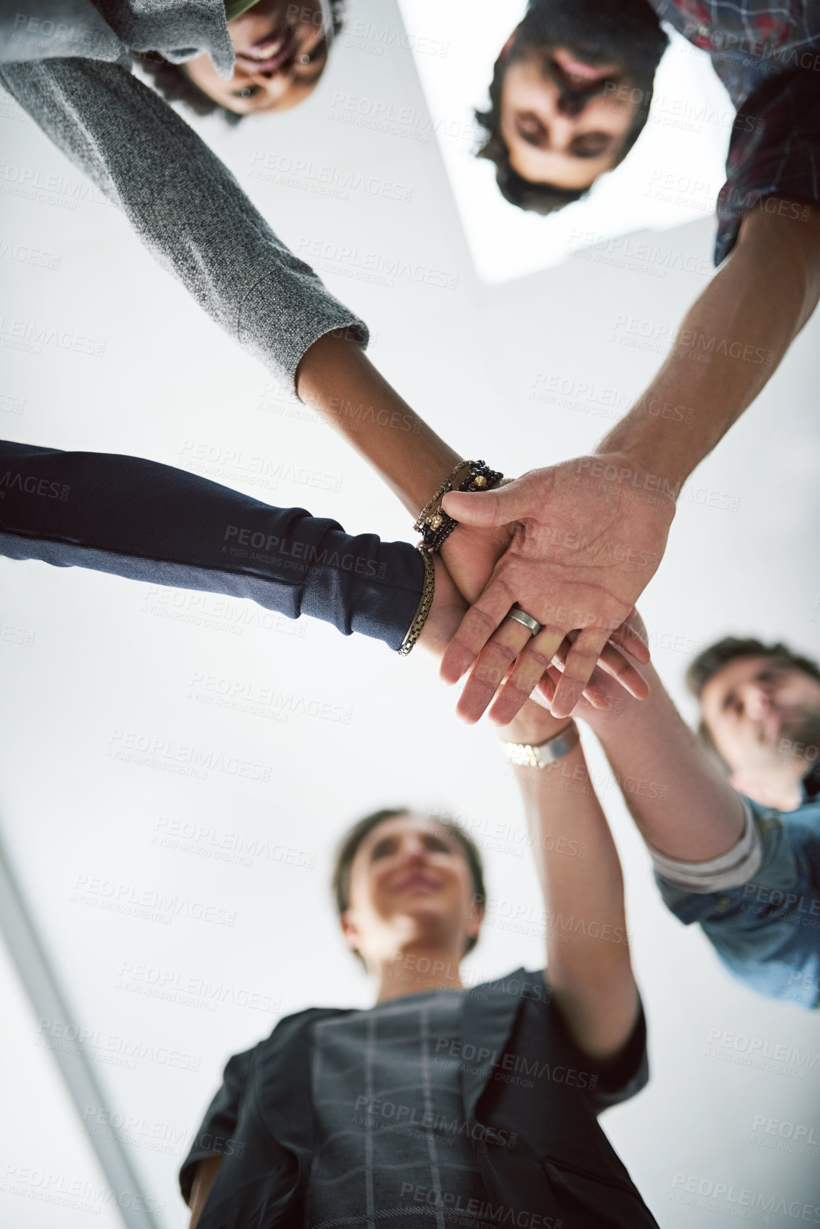Buy stock photo Cropped shot of a group of creative businesspeople stacking their hands on top of each other