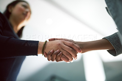 Buy stock photo Cropped shot of two creative businesspeople shaking hands