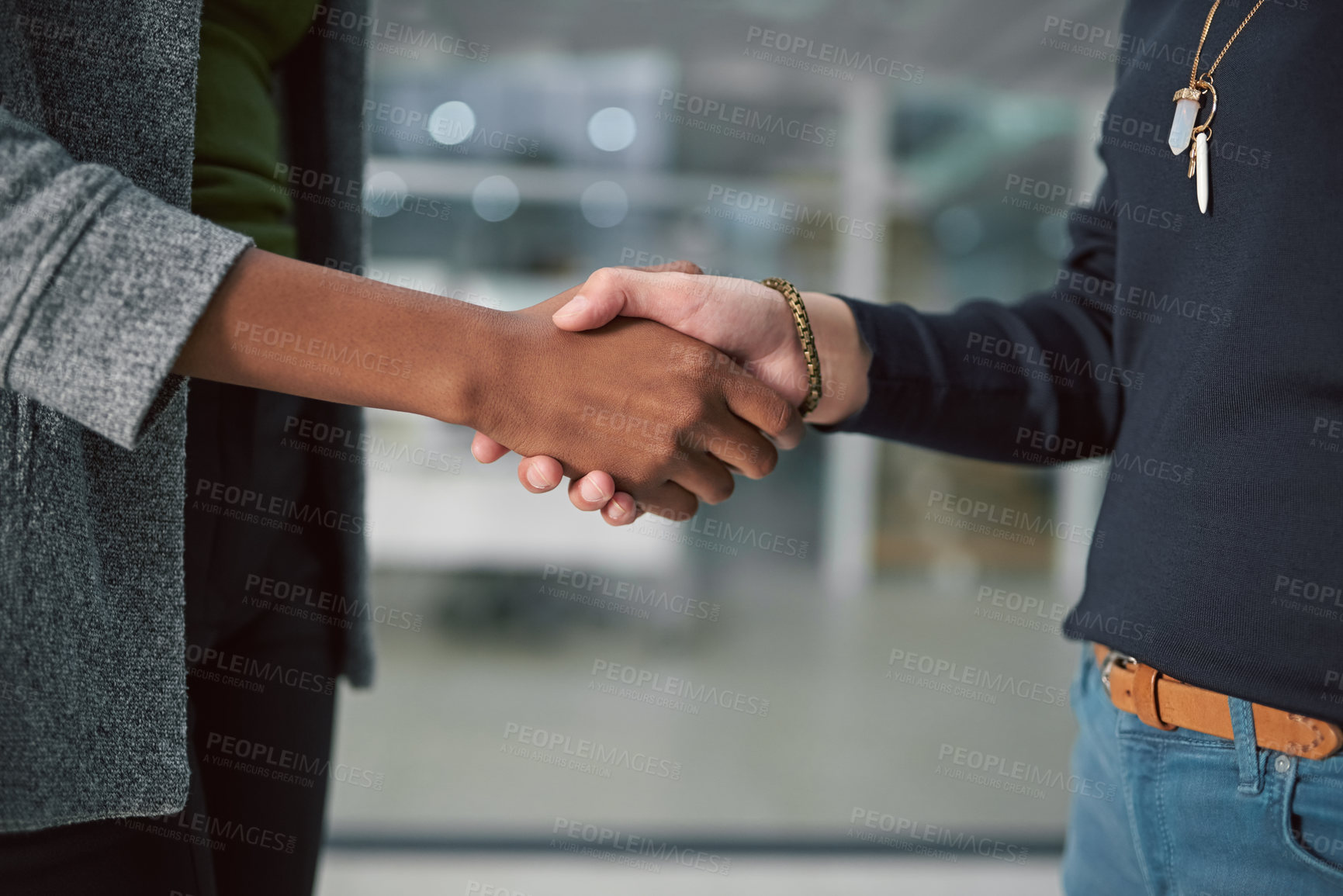 Buy stock photo Cropped shot of two creative businesspeople shaking hands