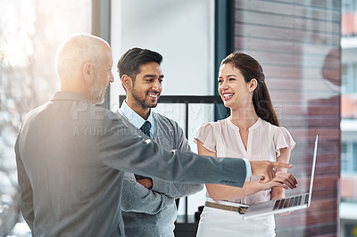 Buy stock photo Collaboration, laptop and smile with business people pointing in office for feedback or review. Management, meeting or teamwork with man and woman employee group in workplace for online report