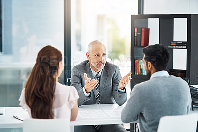 Buy stock photo Cropped shot of three businesspeople meeting in their office