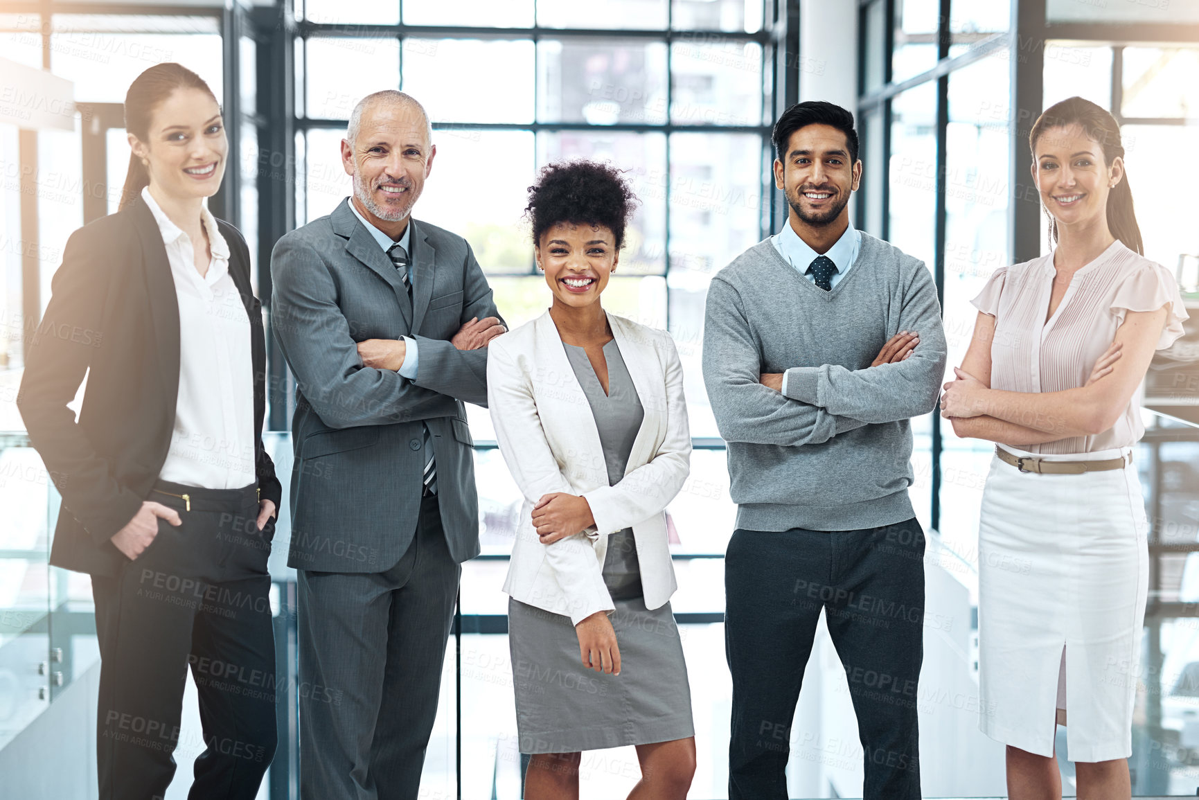 Buy stock photo Portrait of a happy group of colleagues standing together in a modern office