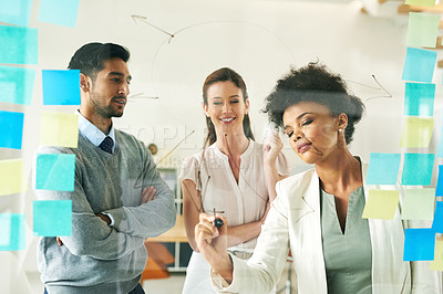 Buy stock photo Shot of a group of young colleagues having a brainstorming session at work