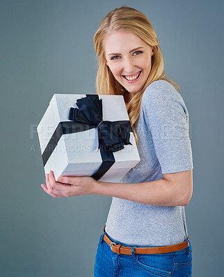 Buy stock photo Cropped studio shot of a happy young woman receiving a present