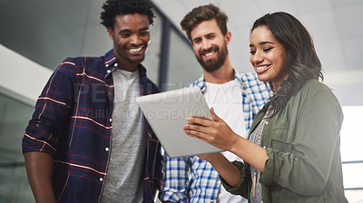 Buy stock photo Cropped shot of three young designers working on a digital tablet in a modern office