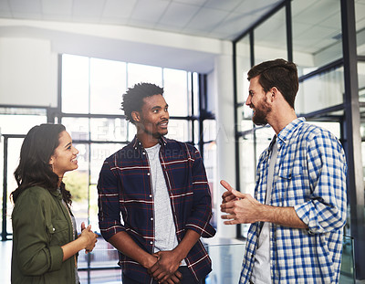 Buy stock photo Cropped shot of three young designers having a discussion in a modern office