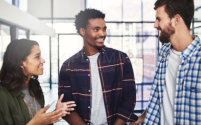Buy stock photo Cropped shot of three young designers having a discussion in a modern office
