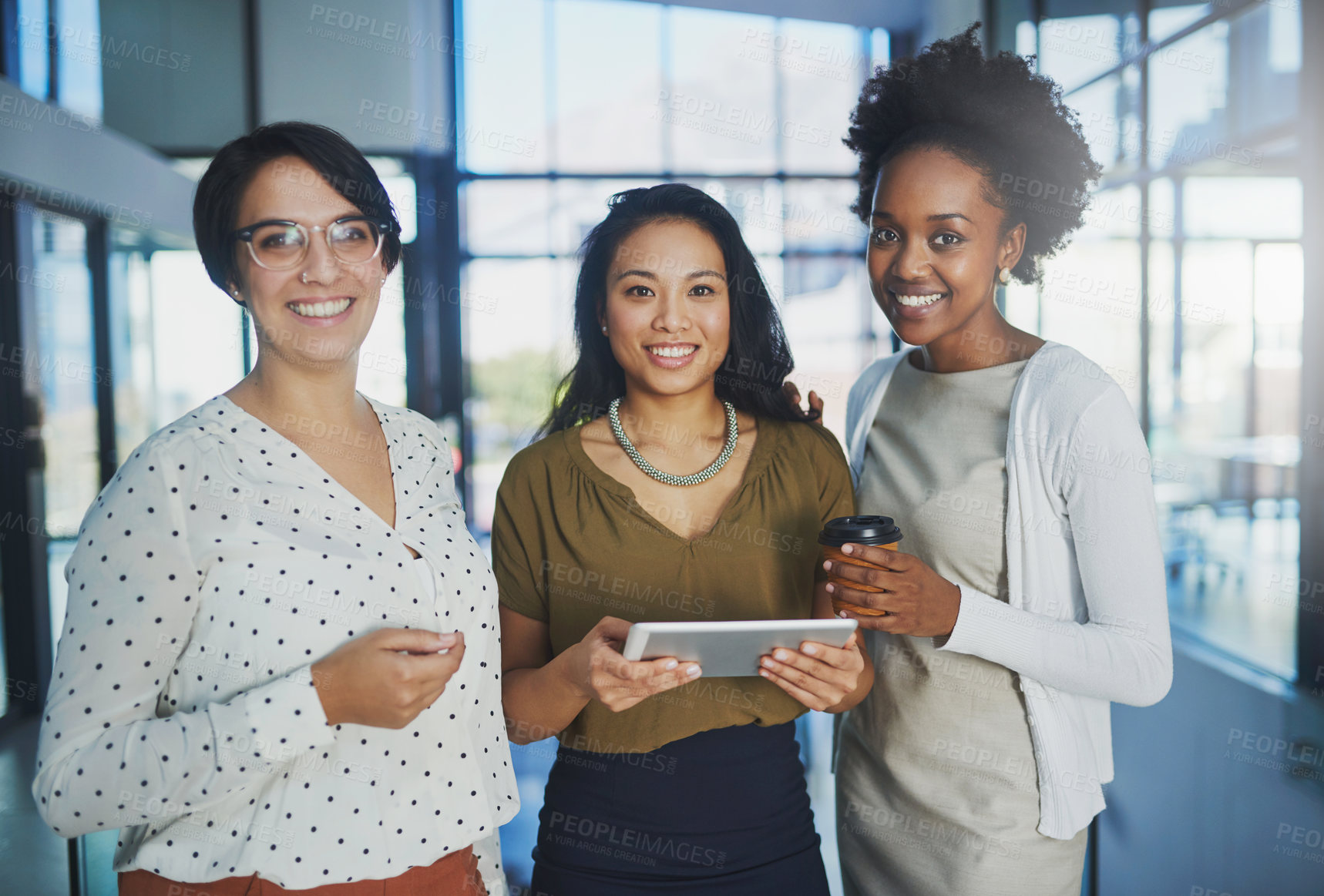 Buy stock photo Cropped portrait of three businesswomen looking at a tablet in the office