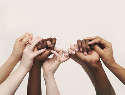 Buy stock photo Cropped shot of a group of hands reaching up and holding on to each other