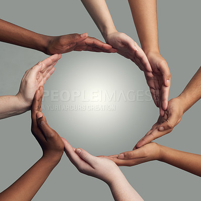 Buy stock photo Cropped shot of a group of hands linking together to form a circle against a grey background